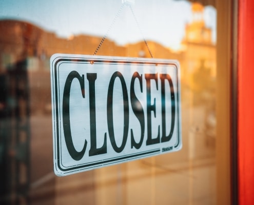 closed sign hanging on window