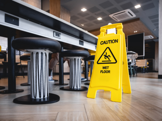 wet floor sign in a public building - slip and fall attorney in boca raton