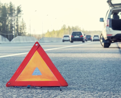 Disabled vehicle sits on grassy shoulder of Florida expressway