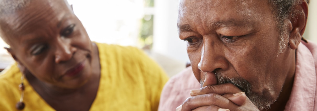 how often does elder abuse occur? Elderly black couple talking about difficult subjects.