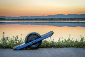 Onewheel infront of a lake.