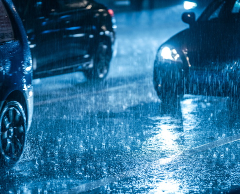 Cars driving on a dark and rainy night