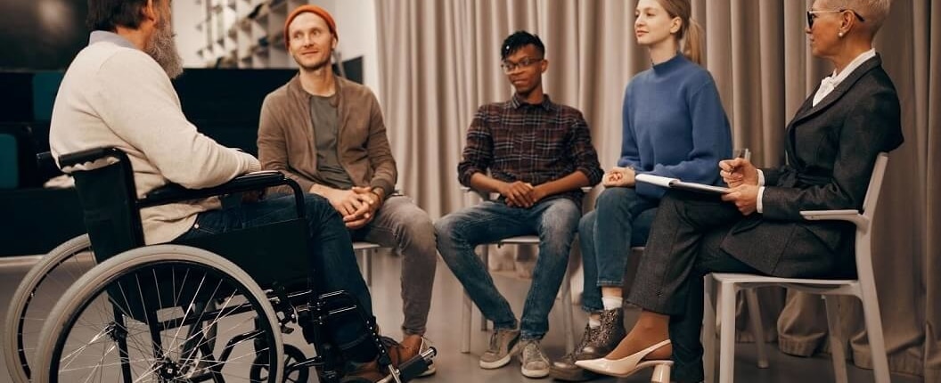 west palm beach brain injury law firm - Support group for individuals sitting in a circle engaged in conversation