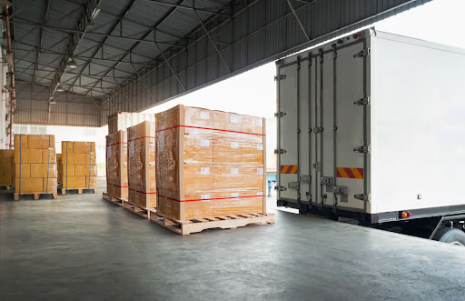 product liability attorneys in fort myers - Semi Trucks preparing to load defective products onto the bed of the truck