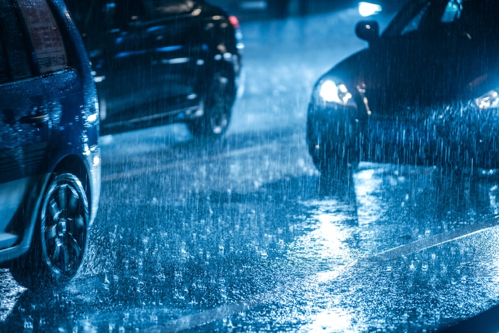 Cars driving on a dark and rainy night