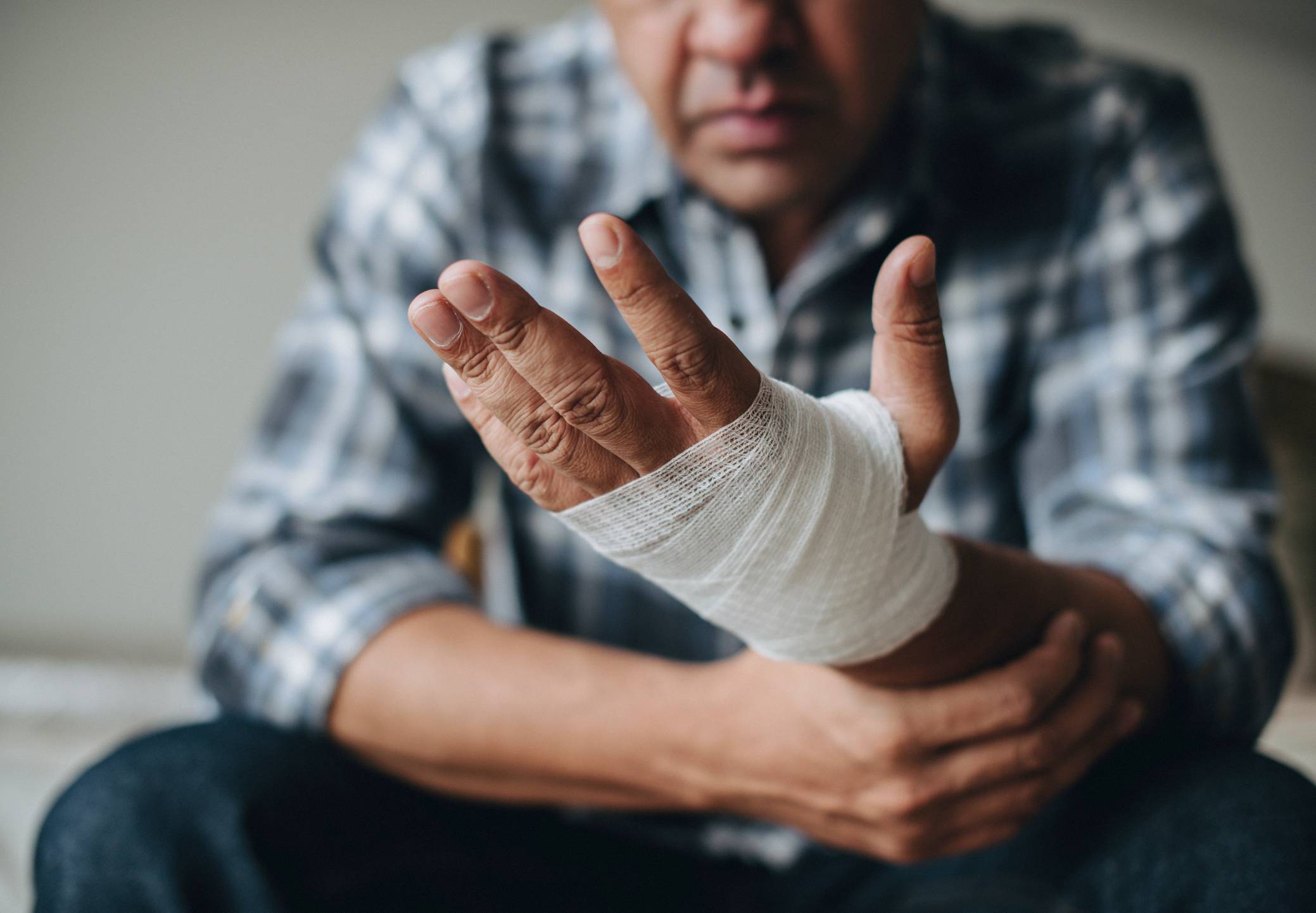 west palm beach personal injury lawyer - Man with a gauze bandage wrapped around his hand