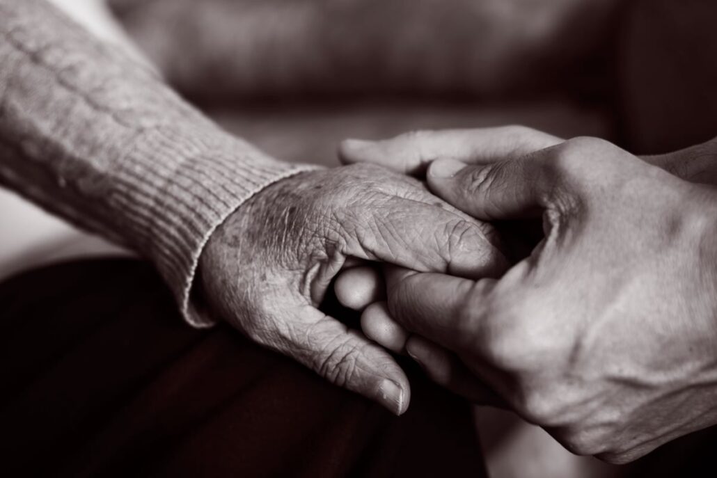 holding elderly person hand