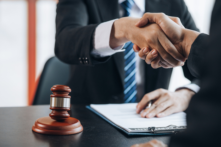 lawyer shaking hands with client - what are the chances of winning a personal injury lawsuit?