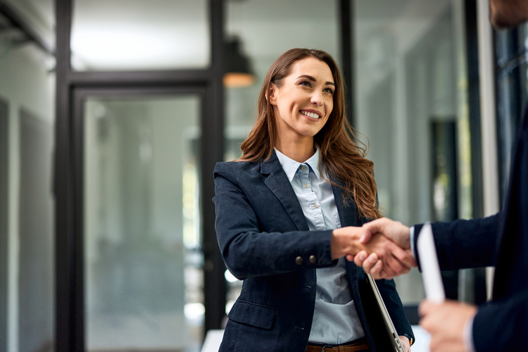 Lawyer shaking hands with client - what should I bring to my first meeting with a personal injury lawyer?