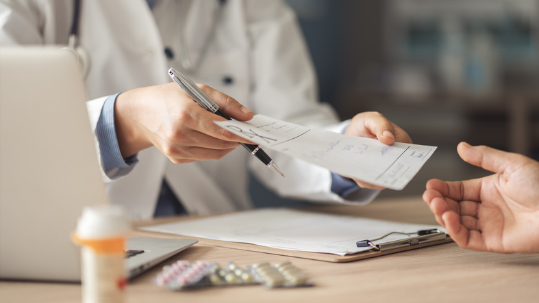doctor handing a patient prescription documents - is medical malpractice civil or criminal?