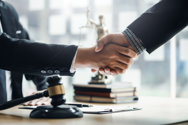 attorney shaking hands with client - How to evaluate a personal injury attorney in West Palm Beach