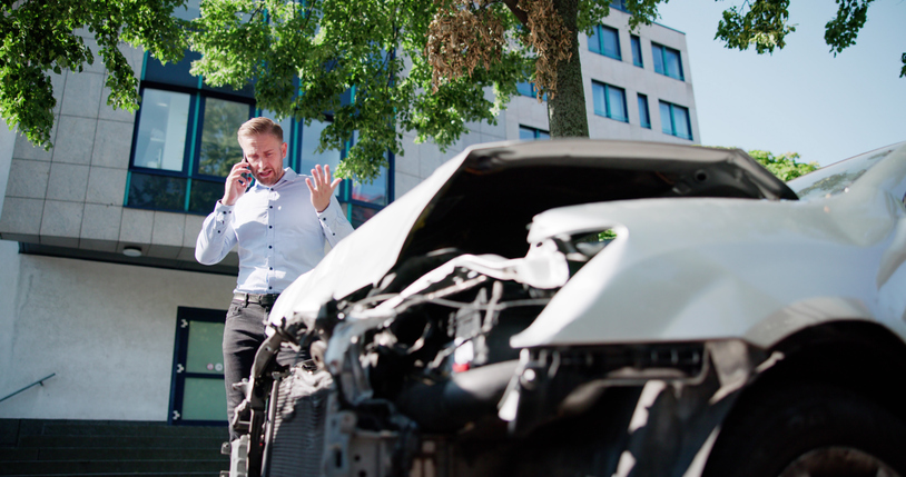 Man making a phone call after a car accident - How accident history influences a personal injury claim