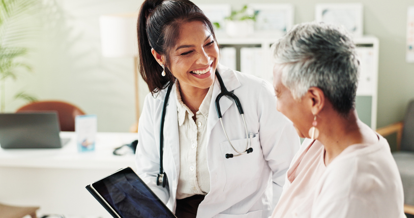Doctor smiling at patient - How to find a doctor after a car accident
